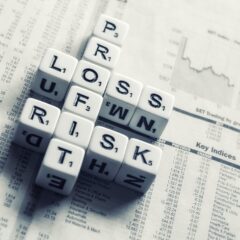 dices over newspaper, profit, loss risk