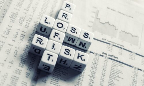 dices over newspaper, profit, loss risk